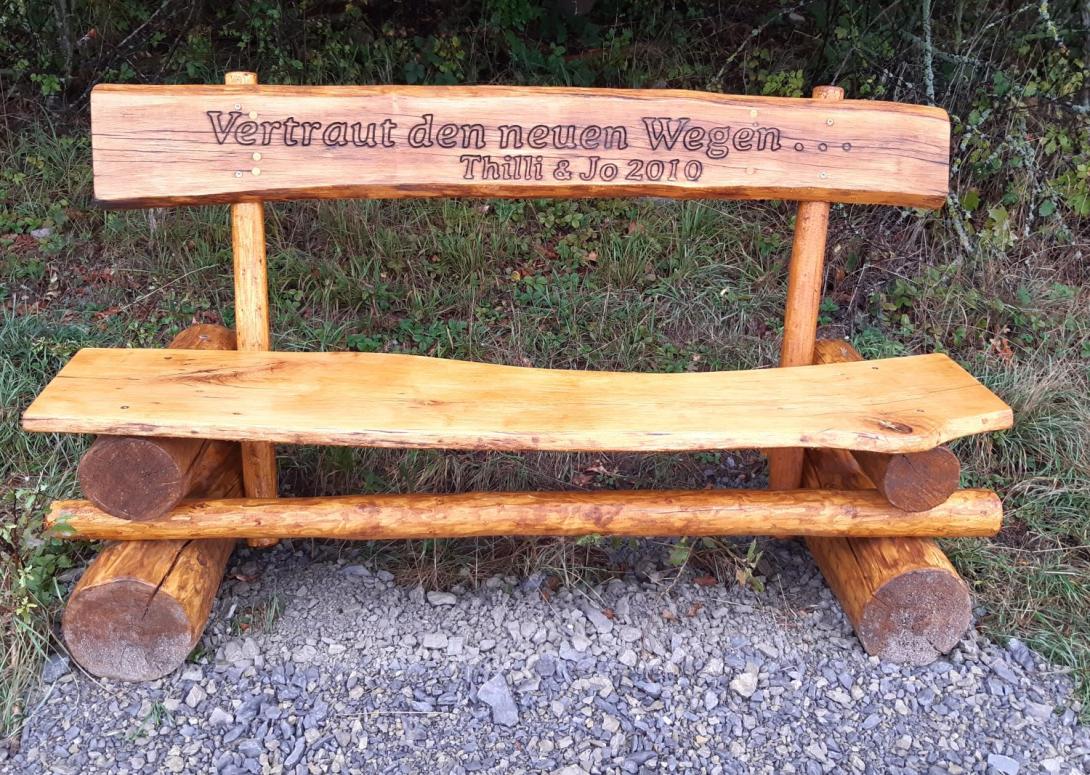 Rustic wooden bench with milled dedication